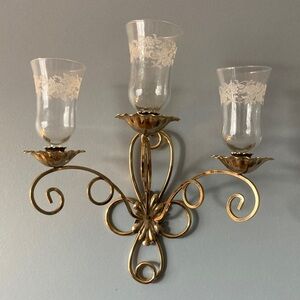 Brass wall sconces with three etched votive candleholders.